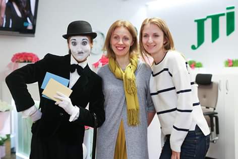 Mime performer in Chaplin style with company staff Berlin